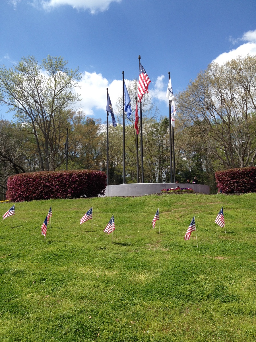 Flagpole Installation in Atlanta 3 FlagCo flagpoles at a veterans memorial with small American flags on the lawn